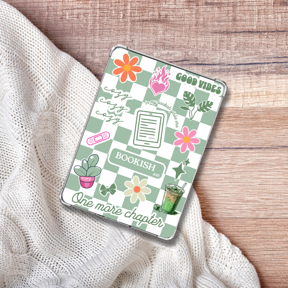 Cozy Matcha Green checkered Kindle Insert for Clear Case on a white blanket and wooden background