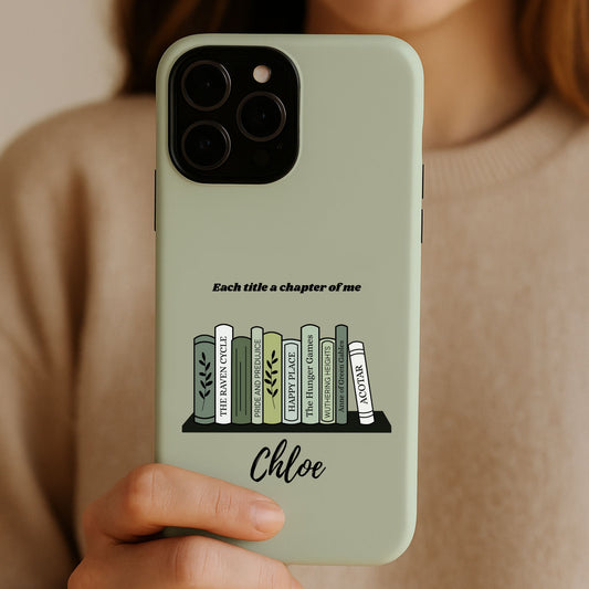 A mockup of a woman holding a green custom bookshelf phone case with her name and fave books | Starlit Prose bookish merch