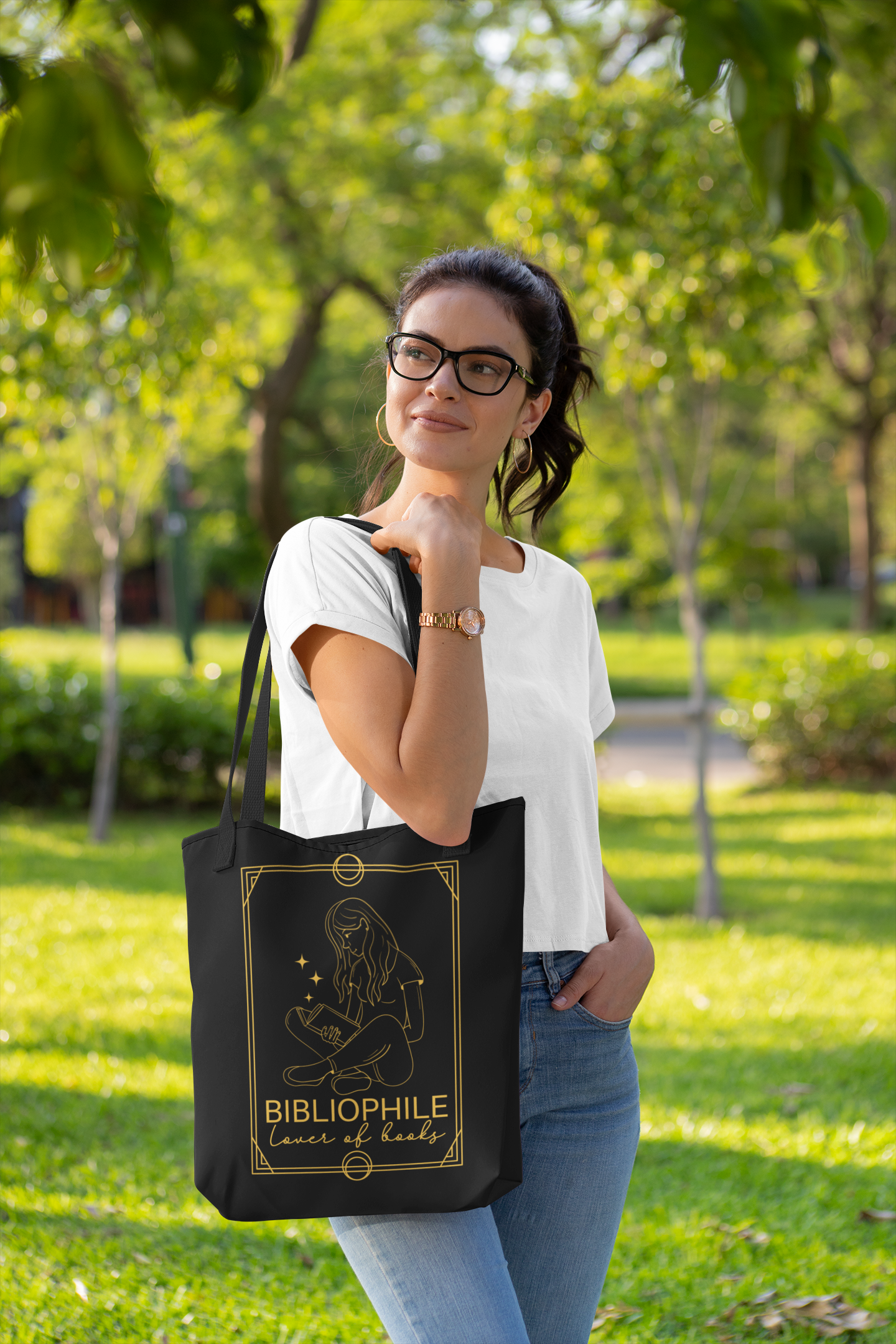Woman in park wearing the Bibliophile Tarot Card Bookish Tote Bag
