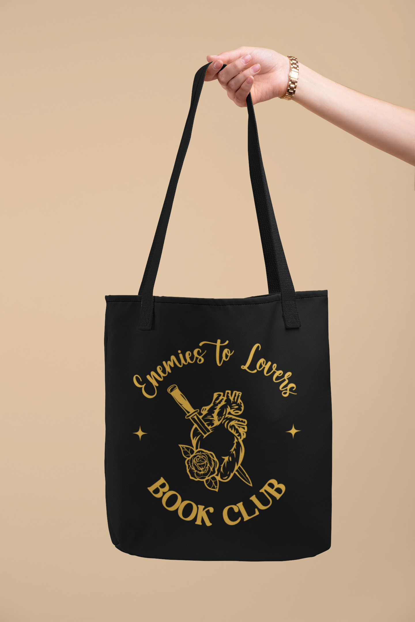 Arm holding out the Enemies to Lovers Book Club Tote Bag |