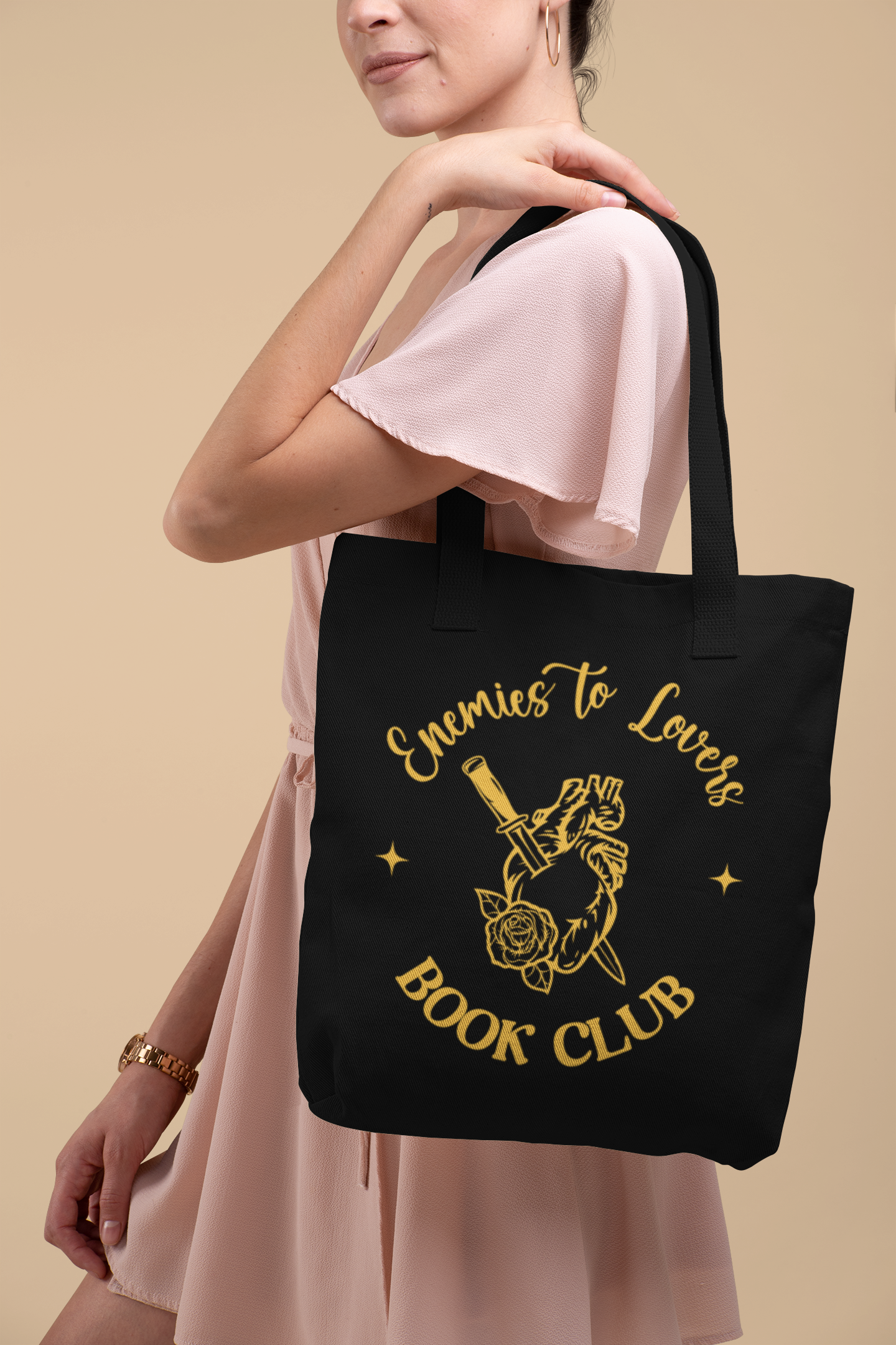 Mock up of woman in pink dress wearing the Enemies to Lovers Book Club Tote Bag |