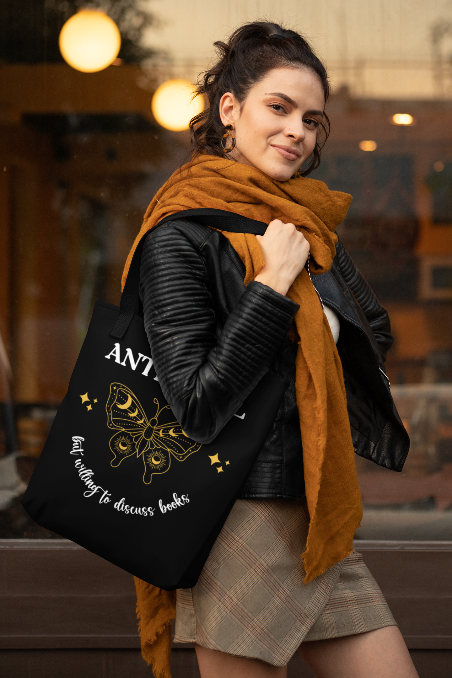 Mockup of a woman with a scarf holding the Antisocial Book Club Tote Bag