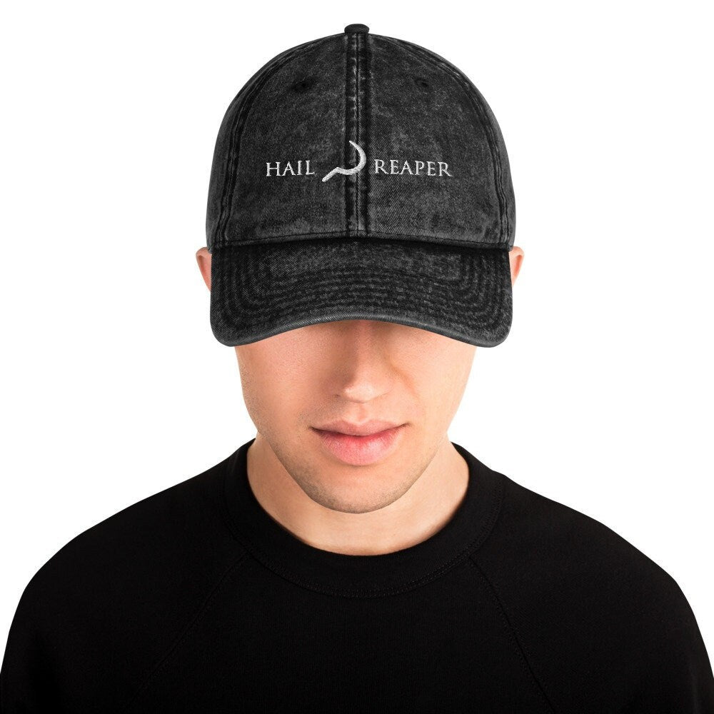A man wearing a hat that says Hail Reaper
