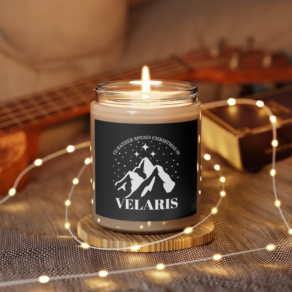A Starlit Prose bookish candle that is black, with graphic of mountains of Velaris, text says "I'd rather be in Velaris for christmas