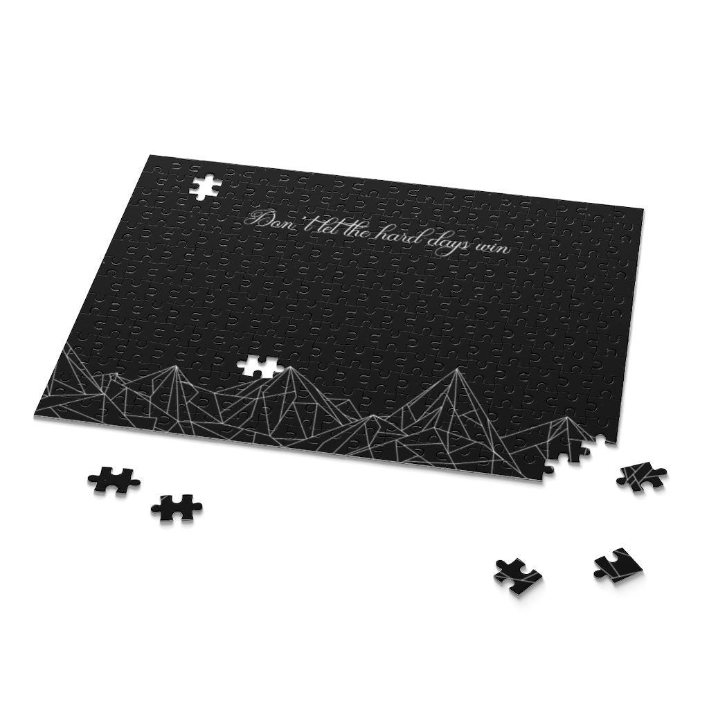 A Starlit Prose bookish puzzle that is inspired by A Court of Thorns and Roses book series by Sarah J Maas. The quote says "Don't let the hard days win" and it has a mountains and stars graphic.