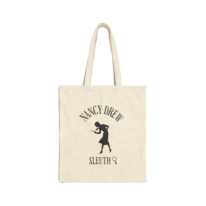 Beige tote bag with Nancy Drew silhouette and text on a white background