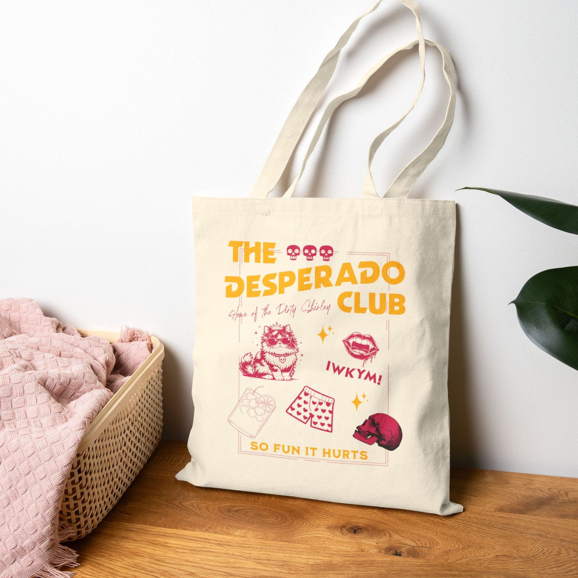 Dungeon Crawler Carl Desperado Club Tote Bag design sitting on a wooden bench | Starlit Prose Bookish Merch Australia