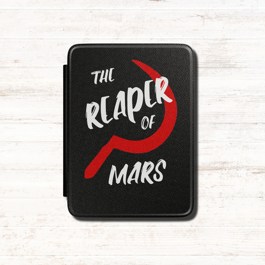 A black textured Red Rising Kindle case featuring the text 'THE REAPER OF MARS' in white and a large red Slingblade. Designed by Starlit Prose Bookish Merch Australia.