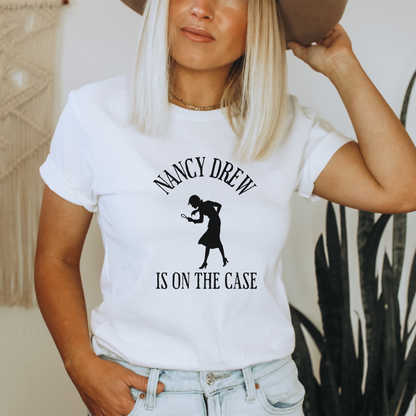 white Shirt that says "Nancy Drew is on the Case" with a sihouette of Nancy Drew