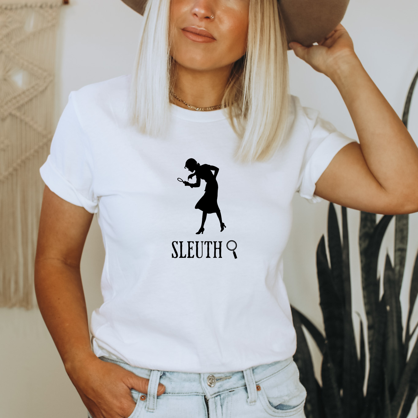 white shirt with a silhouette of nancy Drew that says "Sleuth"
