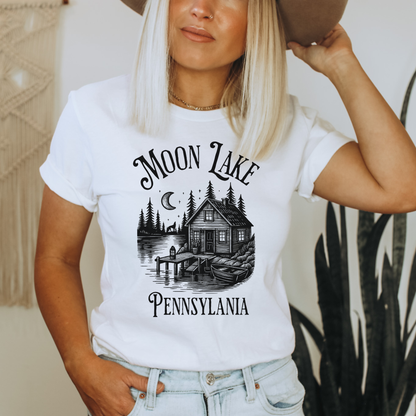 Person wearing a white t-shirt with 'Moon Lake, Pennsylvania' design.