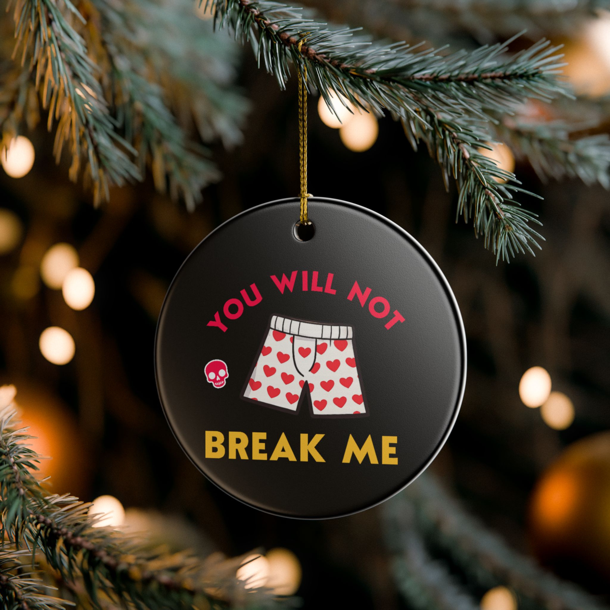 Bookish Ceramic Ornament - Round black Dungeon Crawler Carl Xmas Ornament. It features bold yellow and pink text that says "You Will Not Break Me " with Carl's iconic boxer pajama shorts and a skull. Designed by Starlit Prose Bookish Merch Australia.