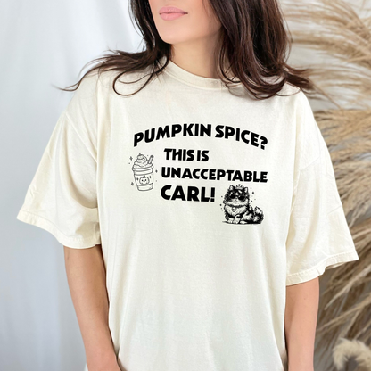 A woman wearing a Ivory Comfort Colors t-shirt with the text 'PUMPKIN SPICE? THIS IS UNACCEPTABLE CARL!' and a pumpkin spice latte, with Princess Donut  illustration. Designed by Starlit Prose Bookish merch Australia