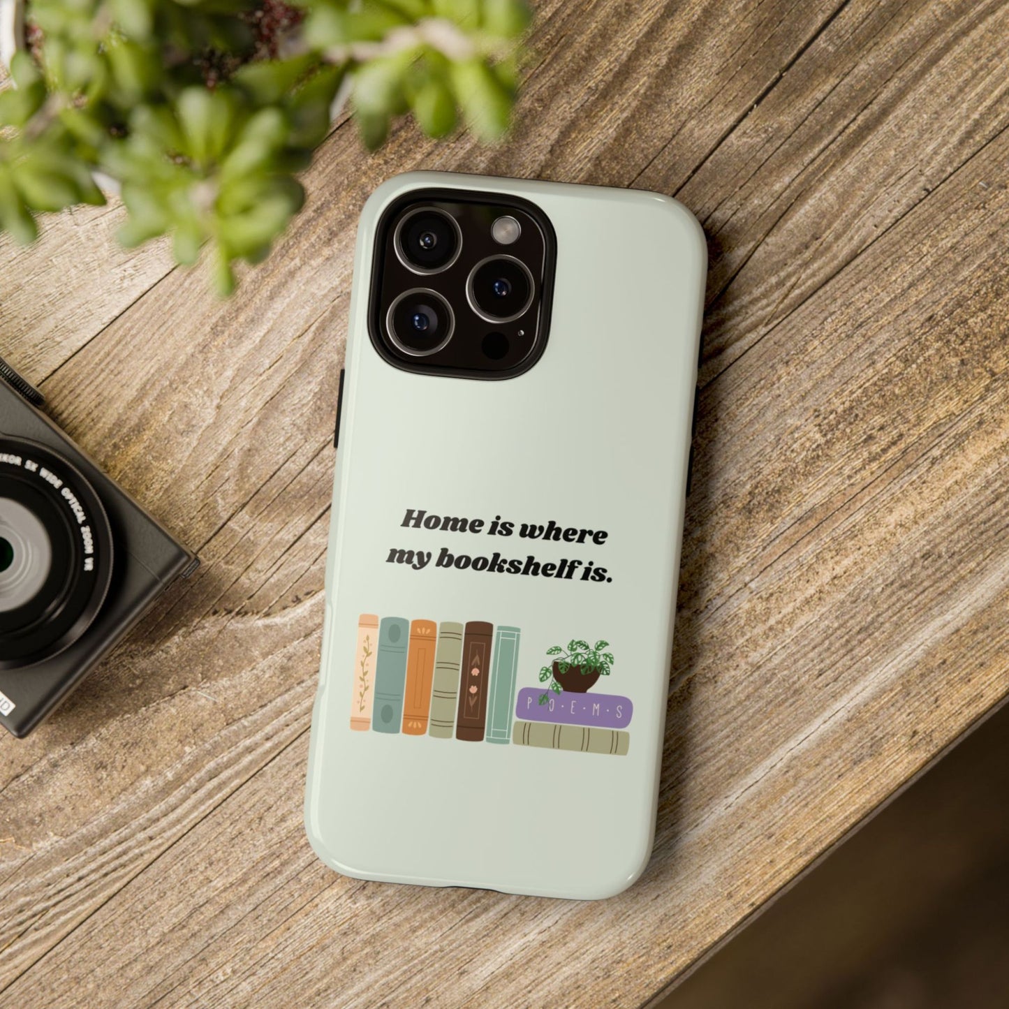 Mockup of  a Green Bookish Tough Phone Case on a wooden background | Starlit Prose Bookish Merch | Gift for Readers