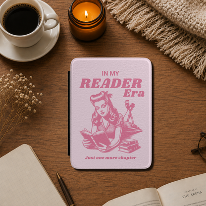 This playful pink Bookish In my Reader Era Kindle case features a vintage pin-up-inspired reader lounging with her book, paired with the phrases "In My Reader Era" and "Just One More Chapter." Pink background. Designed by Starlit Prose Bookish Merch Australia.