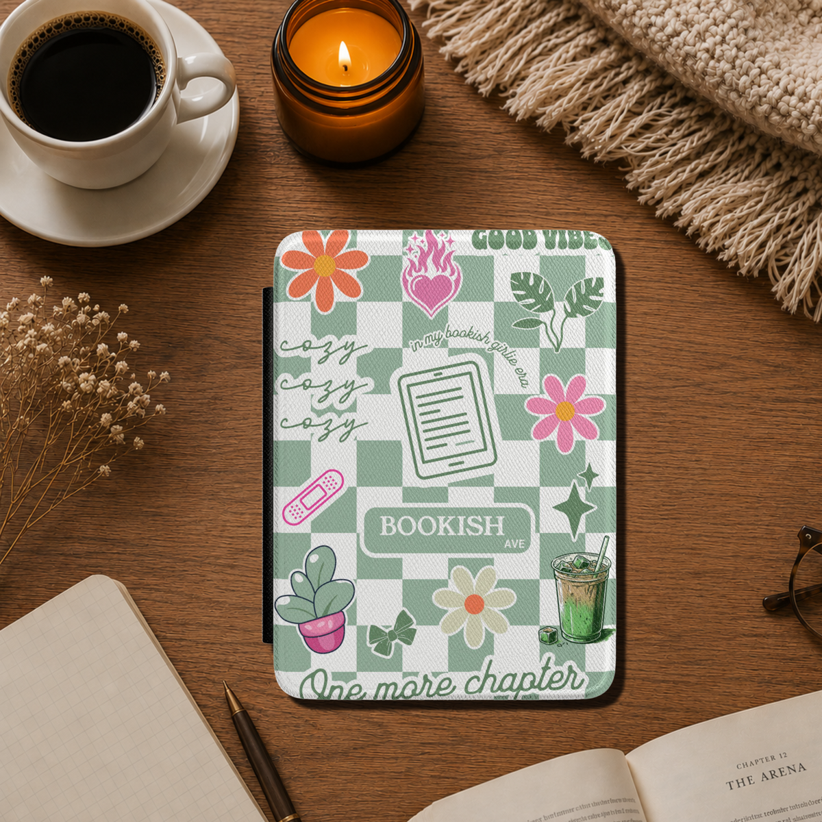  The case has a Matcha green and white checkerboard pattern with floral illustrations, the words 'BOOKISH AVE' and 'GOOD VIBES', One more Chapter, cozy cozy cozy and includes small decorative illustrations like matcha iced latte, coquette bows and a kindle. Designed by Starlit Prose Bookish Merch Australia.