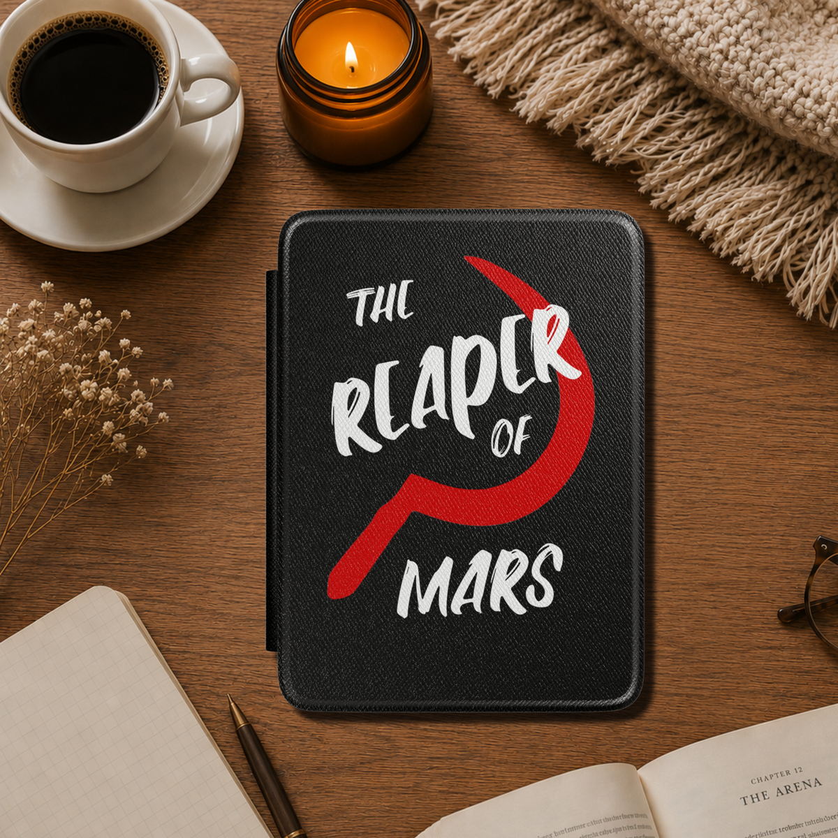 A black textured Red Rising Kindle case featuring the text 'THE REAPER OF MARS' in white and a large red Slingblade. Designed by Starlit Prose Bookish Merch Australia.