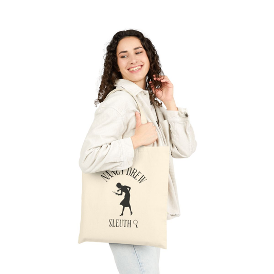 Woman holding a tote bag with 'Nancy Drew Sleuth' design on a white background