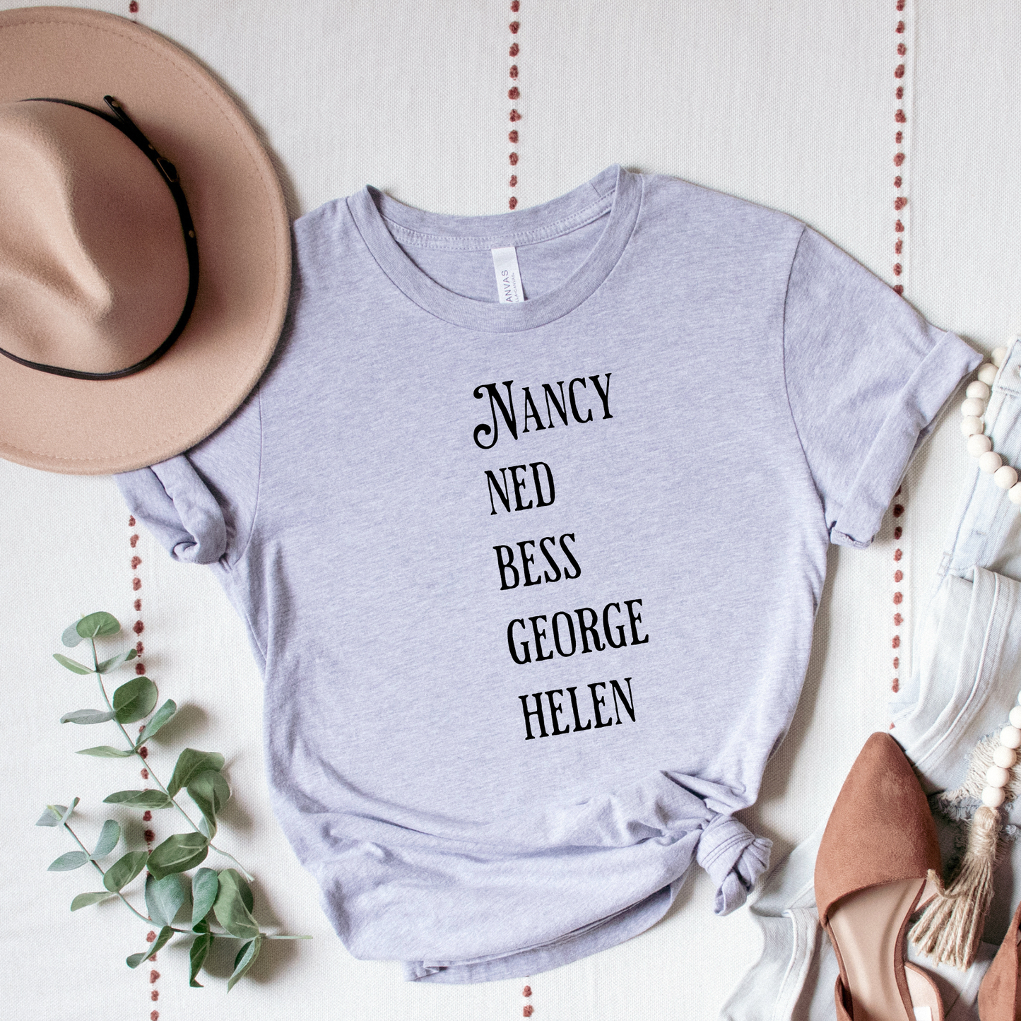 grey shirt with the names of The Clue Crew