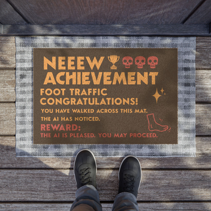 Black Coir Dungeon Crawler Carl Door Mat, text says "New Achievement, Foot traffic, congratulations! you have walked across this mat. the AI has noticed. Reward- The ai is pleased, you may proceed.Includes illustration of foot, stars & skulls. Designed by Starlit Prose Bookish Merch Australia.