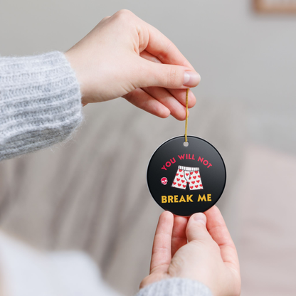 Bookish Ceramic Ornament - Round black Dungeon Crawler Carl Xmas Ornament. It features bold yellow and pink text that says "You Will Not Break Me " with Carl's iconic boxer pajama shorts and a skull. Designed by Starlit Prose Bookish Merch Australia.