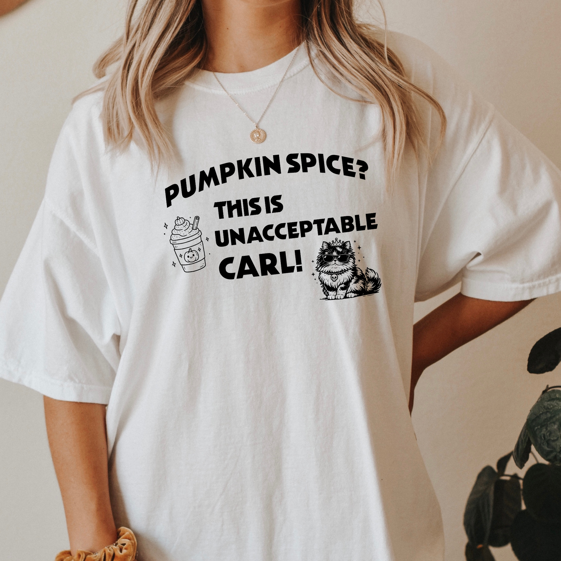A woman wearing a White Comfort Colors t-shirt with the text 'PUMPKIN SPICE? THIS IS UNACCEPTABLE CARL!' and a pumpkin spice latte, with Princess Donut  illustration. Designed by Starlit Prose Bookish merch Australia