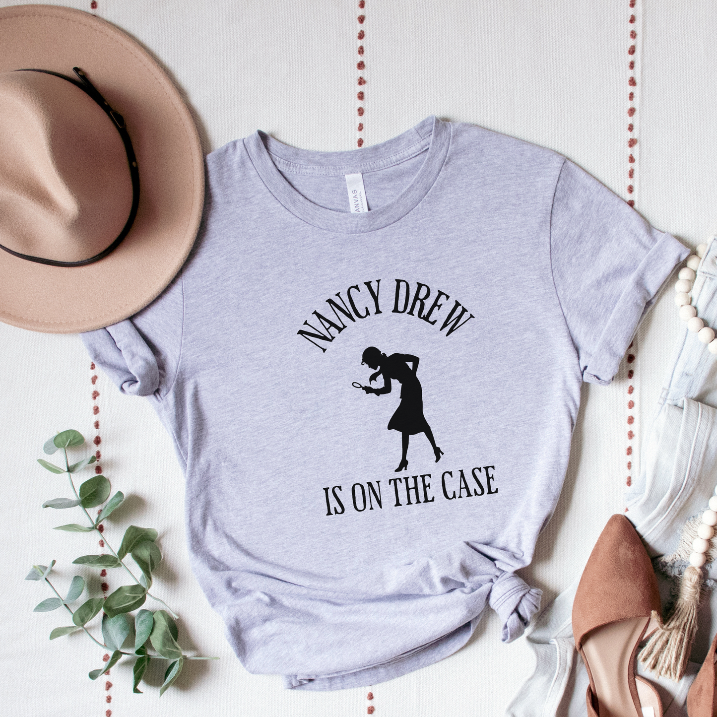 grey Shirt that says "Nancy Drew is on the Case" with a sihouette of Nancy Drew