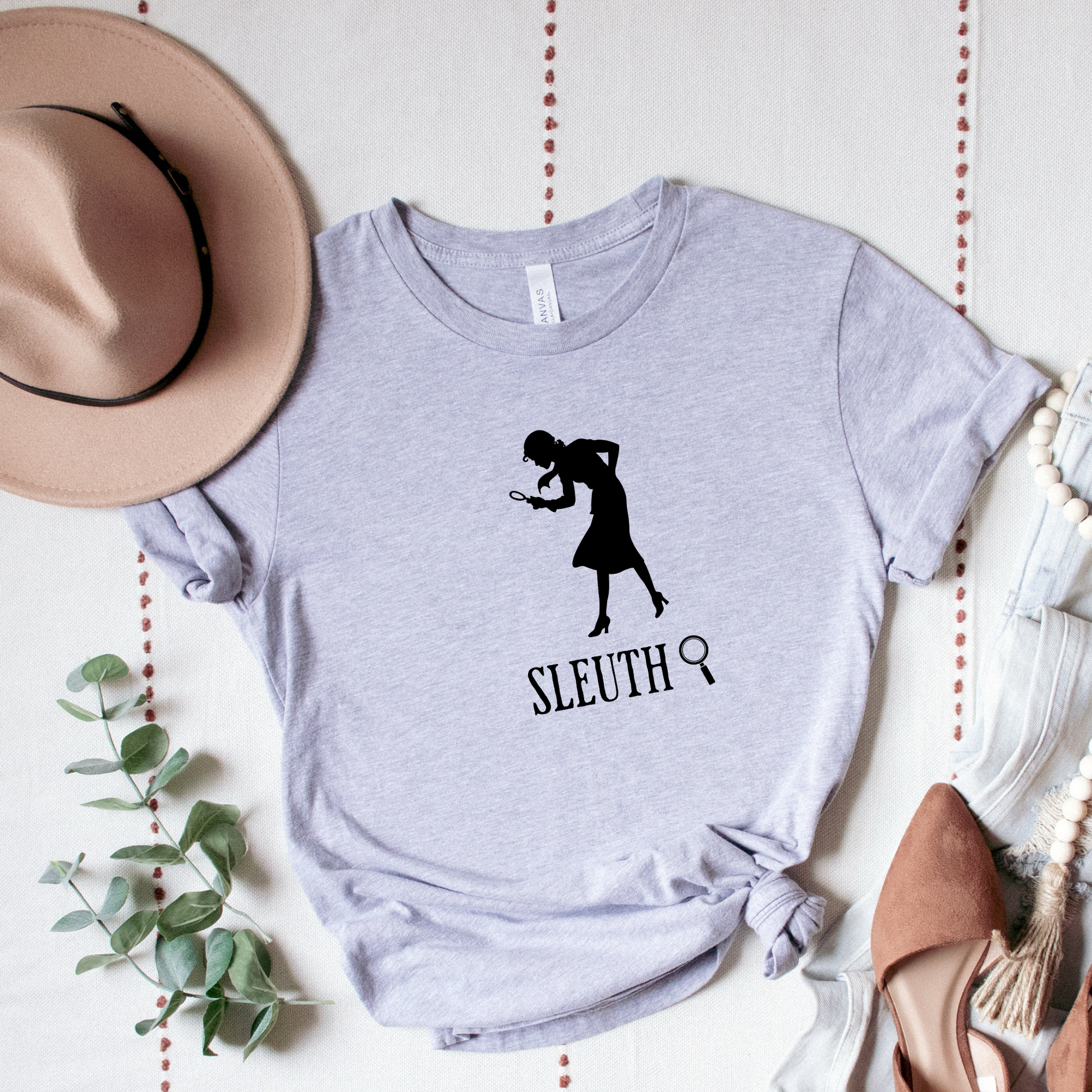 grey shirt with a silhouette of nancy Drew that says "Sleuth"