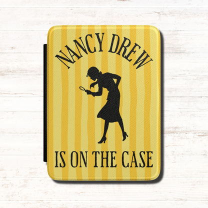 A Nancy Drew Kindle Case that features yellow stripes, with a black silhouette of Nancy Drew with a magnifying glass and the text 'NANCY DREW IS ON THE CASE'. Designed by Starlit Prose Bookish Merch Australia.