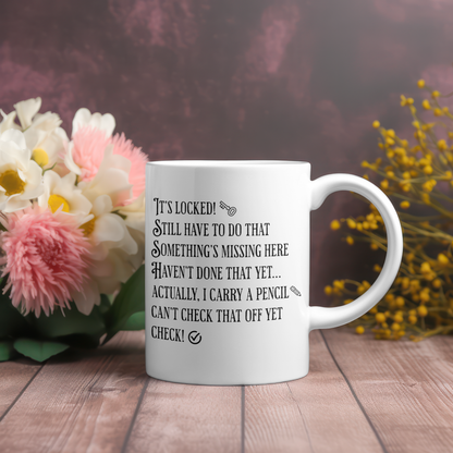 White mug with text from the Nancy Drew Her Interactive video game on a wooden surface with flowers in the background