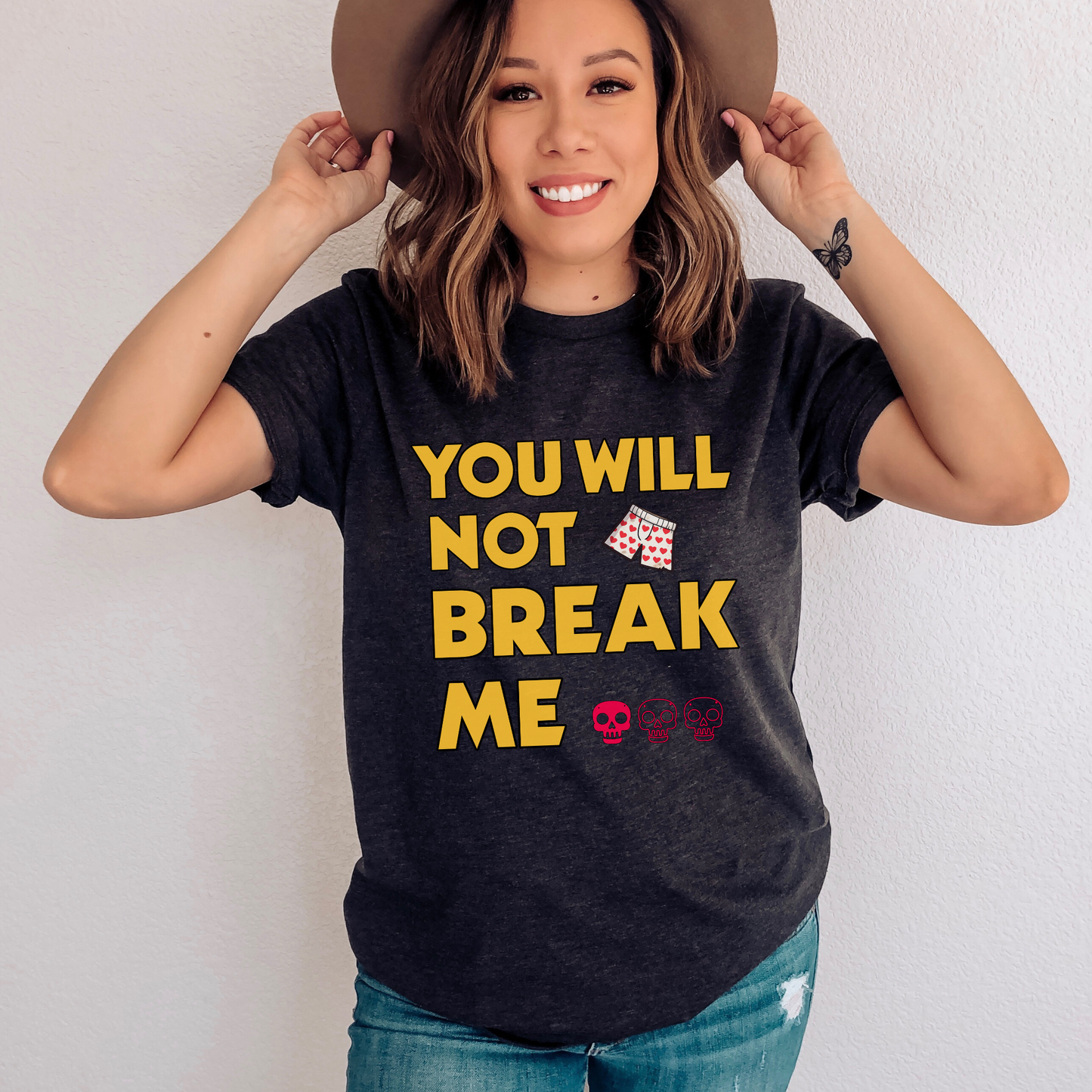 Person wearing a Dark Grey Heather t-shirt with 'You will not break me' text and skull emojis | Dungeon Crawler Carl Merch | Starlit Prose Bookish Merch Australia