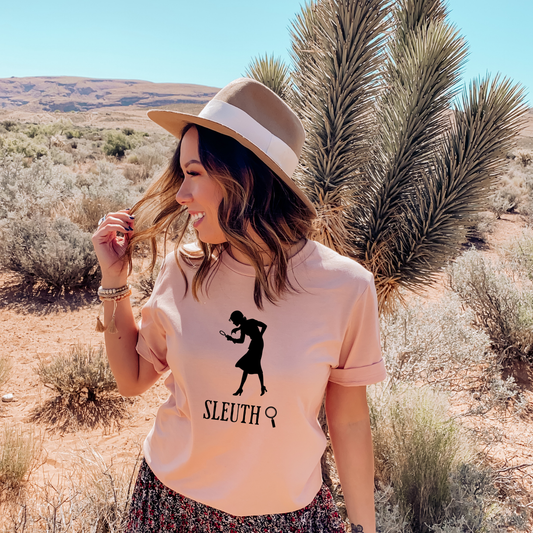 Heather Peach shirt with a silhouette of nancy Drew that says "Sleuth"