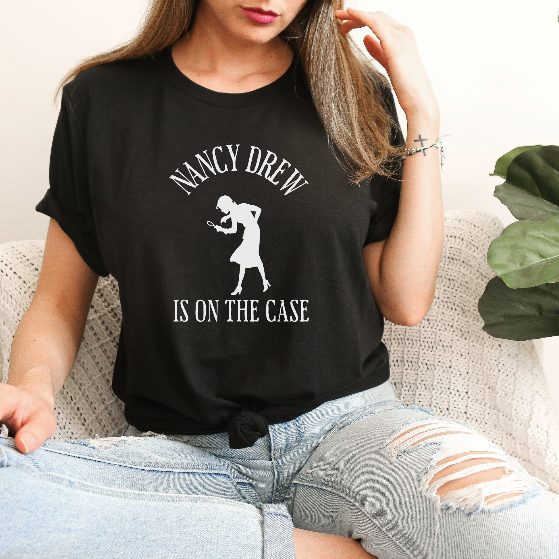black Shirt that says "Nancy Drew is on the Case" with a sihouette of Nancy Drew