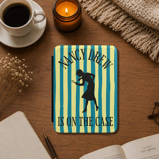 A Nancy Drew Kindle Case that features yellow and blue stripes, with a black silhouette of Nancy Drew with a magnifying glass and the text 'NANCY DREW IS ON THE CASE'. Designed by Starlit Prose Bookish Merch Australia.