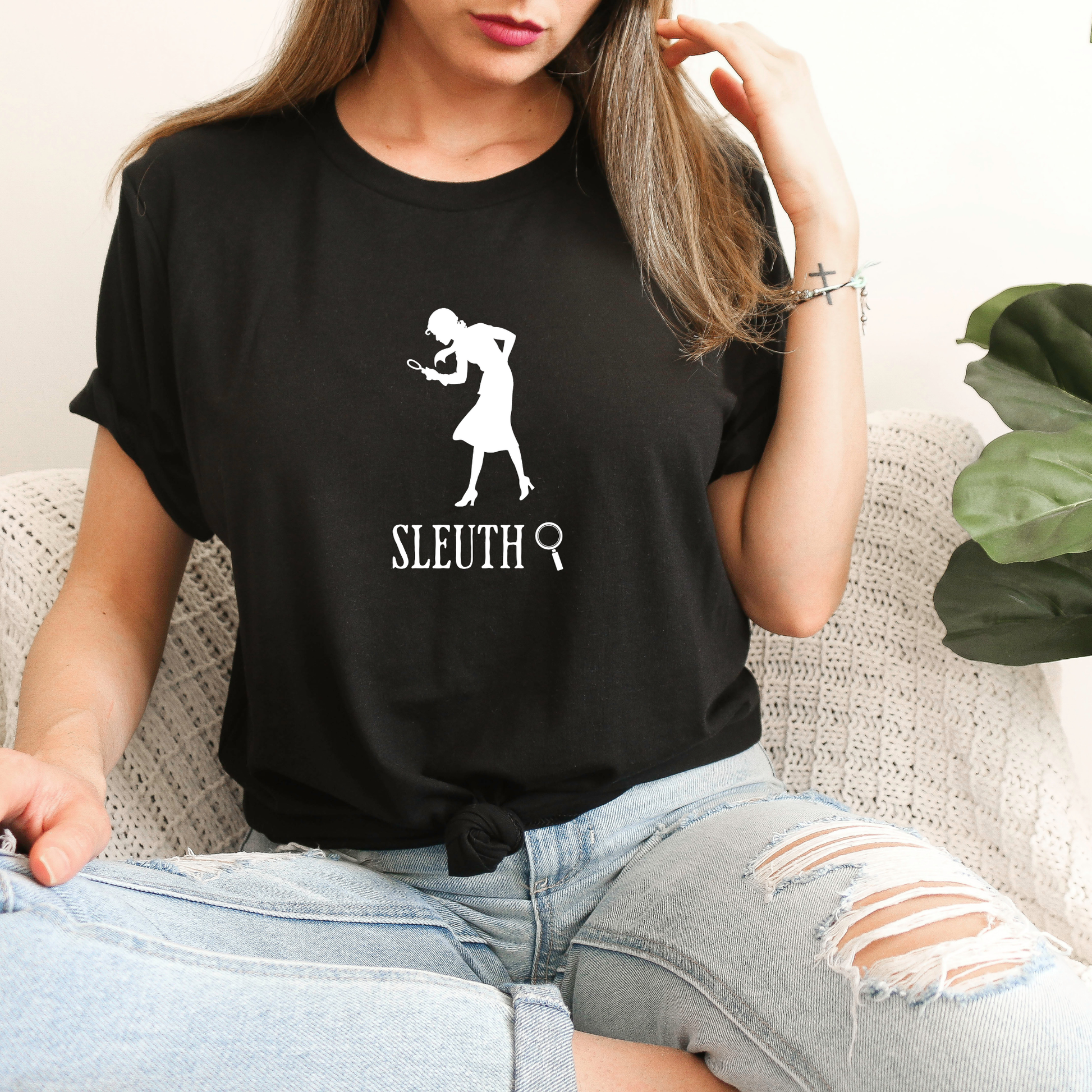 black shirt with a silhouette of nancy Drew that says "Sleuth"