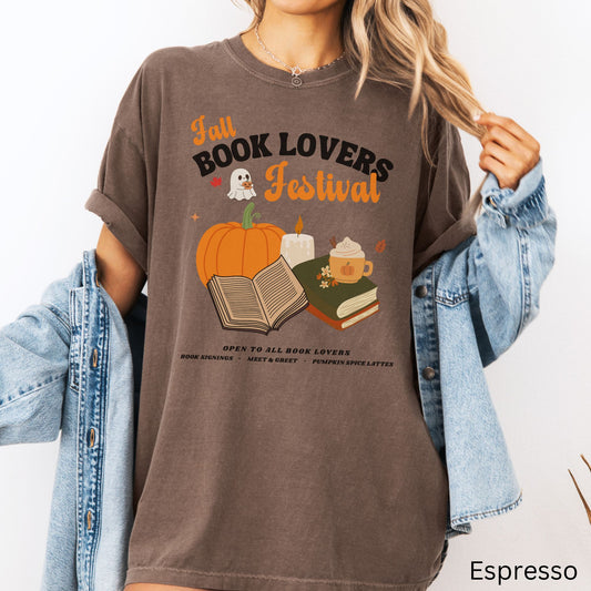 Woman wearing an Espresso Brown Comfort Colors Tshirt with 'Fall Book Lovers Festival' design featuring a pumpkin, books, and a ghost for a fictional Book Lovers Festival. Starlit Prose Bookish Merch Australia