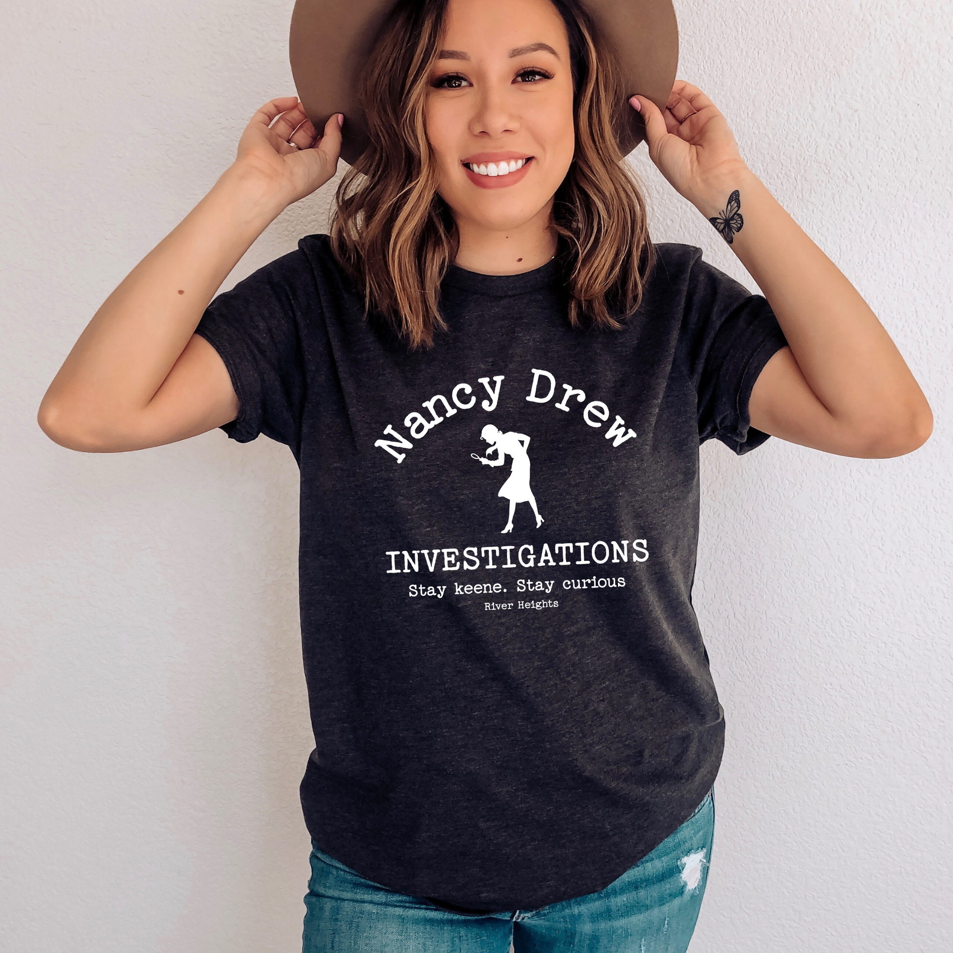 dark grey heather shirt with the text "Nancy Drew Investigations" with silhouette of Nancy 