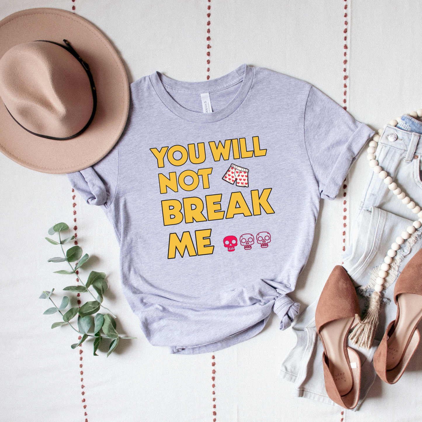 Person wearing a Heather Grey t-shirt with 'You will not break me' text and skull emojis | Dungeon Crawler Carl Merch | Starlit Prose Bookish Merch Australia