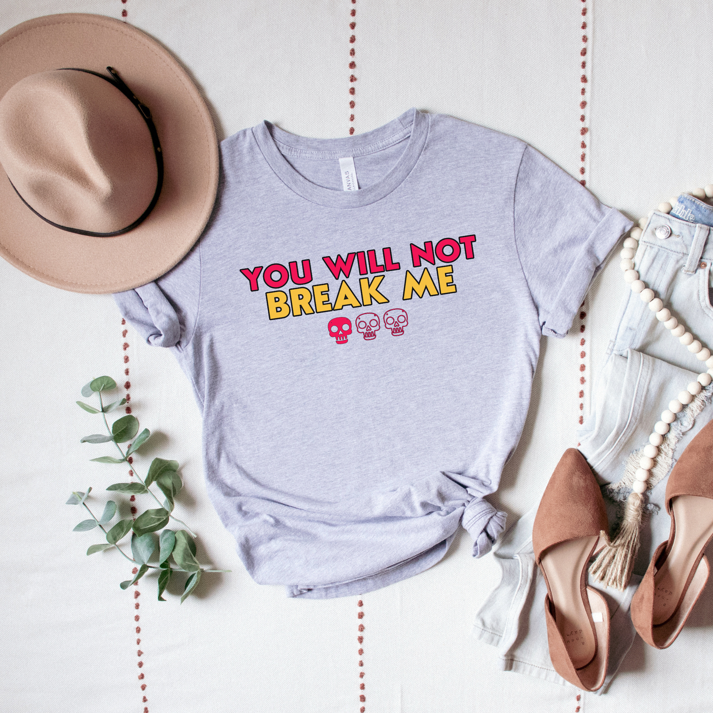 Person wearing a Grey Heather t-shirt with 'YOU WILL NOT BREAK ME' text design inspired by Dungeon Crawler Carl | Starlit Prose Bookish Merch Australia