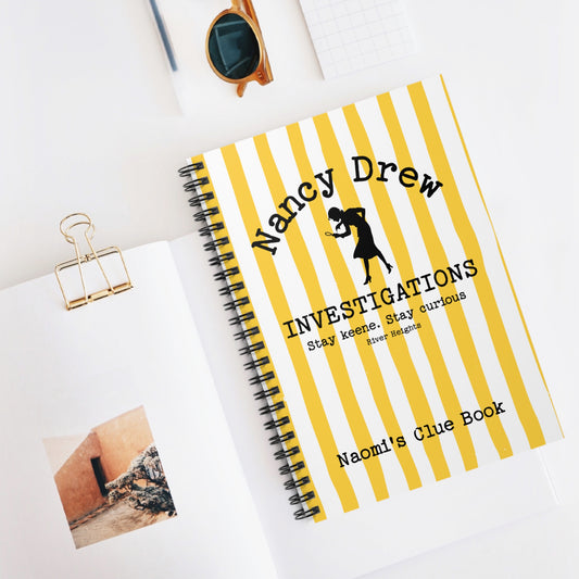 Bookish Notebook design features a cheerful yellow and white striped background with a Nancy Drew Investigations theme and a personalised section where you can add the recipient's name. It includes an icon of Nancy Drew with her magnifying glass. Designed by Starlit Prose Bookish Merch Australia.