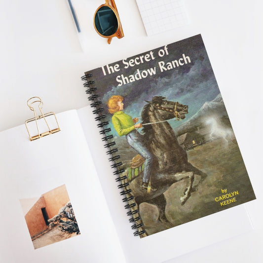 This Nancy Drew bookish notebook features the classic book cover design of The Secret of Shadow Ranch by Carolyn Keene. Designed by Starlit Prose Bookish Merch Australia.
