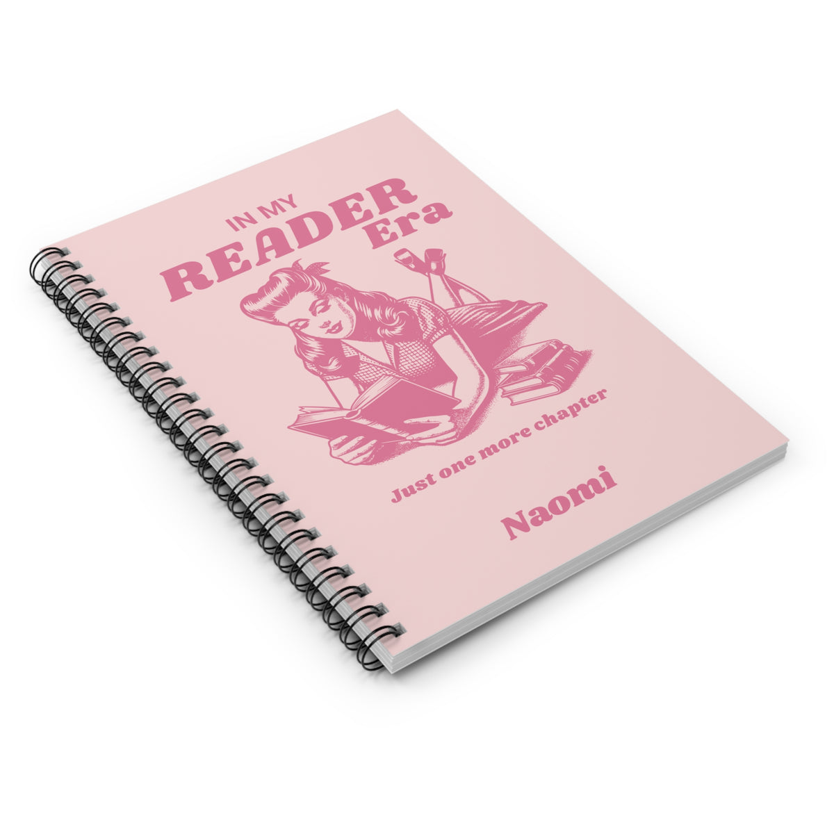 This cute bookish personalised spiral notebook features a soft light pink background, a vintage-inspired pin-up girl reading a book and the phrases "In My Reader Era" and "Just One More Chapter." A personalised section allows you to add the recipient's name, turning an already bookish design into a thoughtful gift made especially for them. Designed by Starlit Prose Bookish Merch Australia.