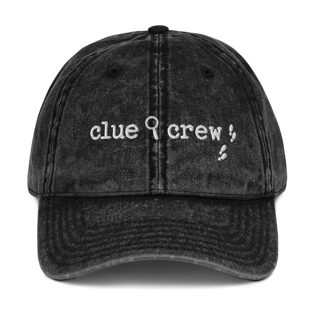 A Nancy Drew vintage distressed style embroidered Dad hat features “Clue Crew” alongside a magnifying glass and tiny footsteps. Designed by Starlit Prose Bookish Merch Australia.