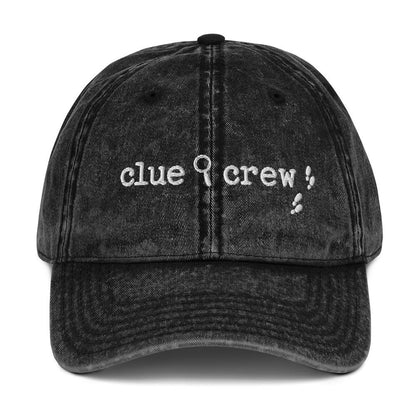 A Nancy Drew vintage distressed style embroidered Dad hat features “Clue Crew” alongside a magnifying glass and tiny footsteps. Designed by Starlit Prose Bookish Merch Australia.