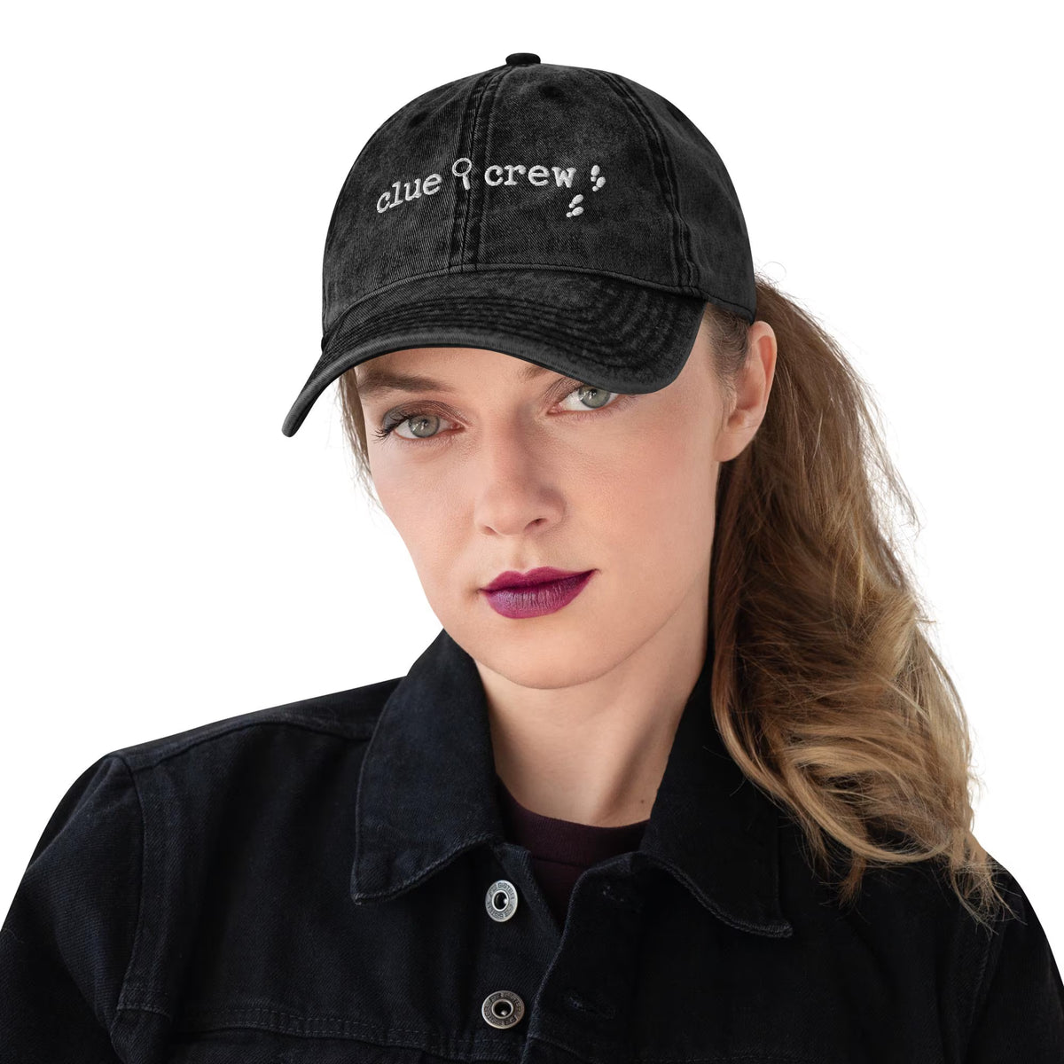 A Nancy Drew vintage distressed style embroidered Dad hat features “Clue Crew” alongside a magnifying glass and tiny footsteps. Designed by Starlit Prose Bookish Merch Australia.