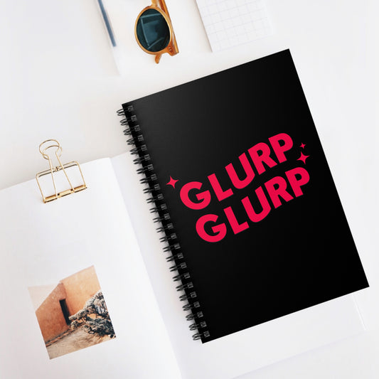 A black Dungeon Crawler Carl bookish spiral notebook, it has red text that says "Glurp Glurp" bold with some accent stars. Designed by Starlit Prose Bookish Merch Ausralia.