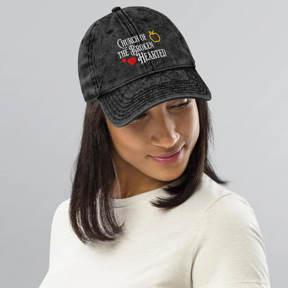 Once Upon a Broken Heart embroidered hat , distressed Vintage style hat features text that says “Church of the Broken Hearted”, with a delicate gold apple outline, and tiny red hearts. Designed by Starlit Prose Bookish Merch Australia.