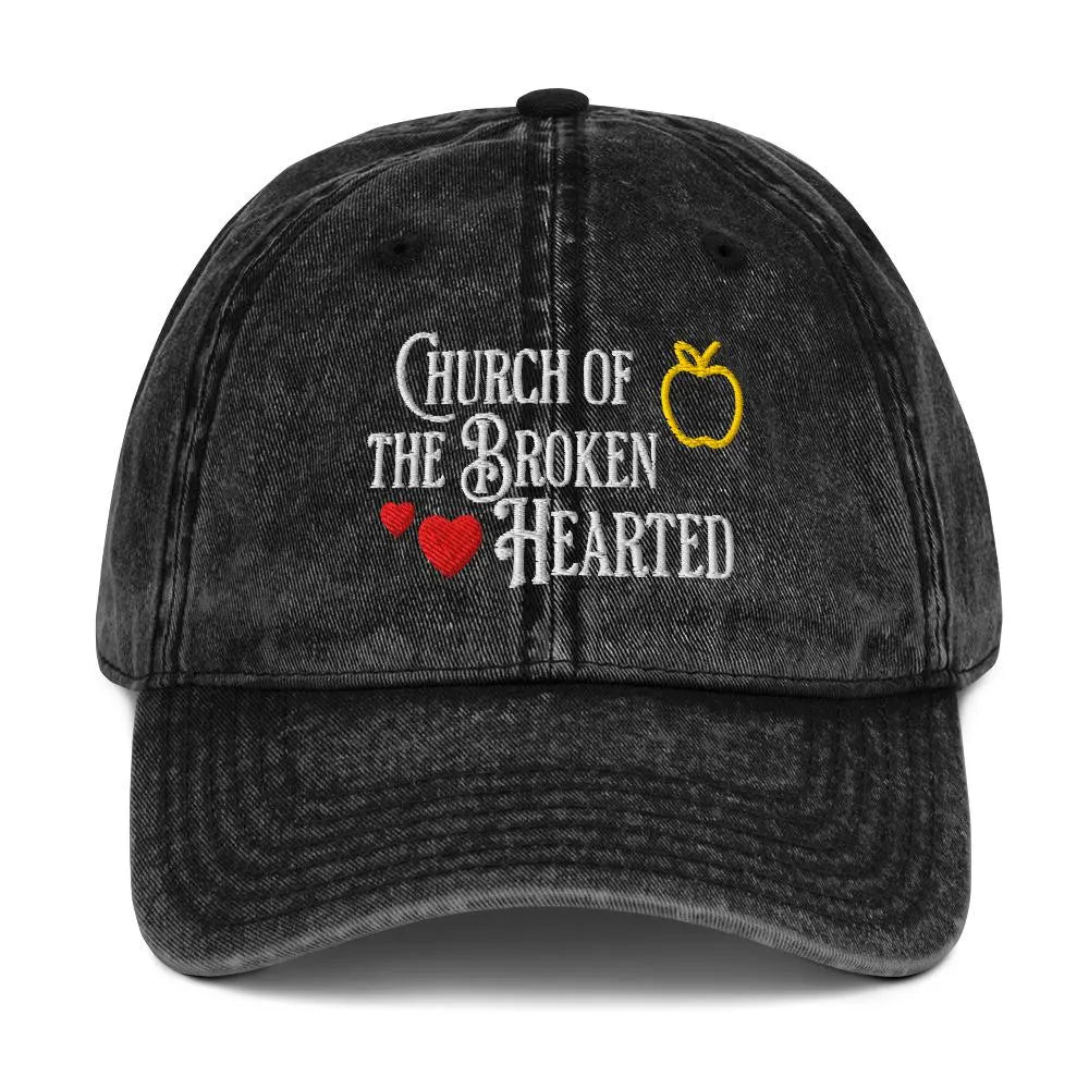 Once Upon a Broken Heart embroidered hat , distressed Vintage style hat features text that says “Church of the Broken Hearted”, with a delicate gold apple outline, and tiny red hearts. Designed by Starlit Prose Bookish Merch Australia.