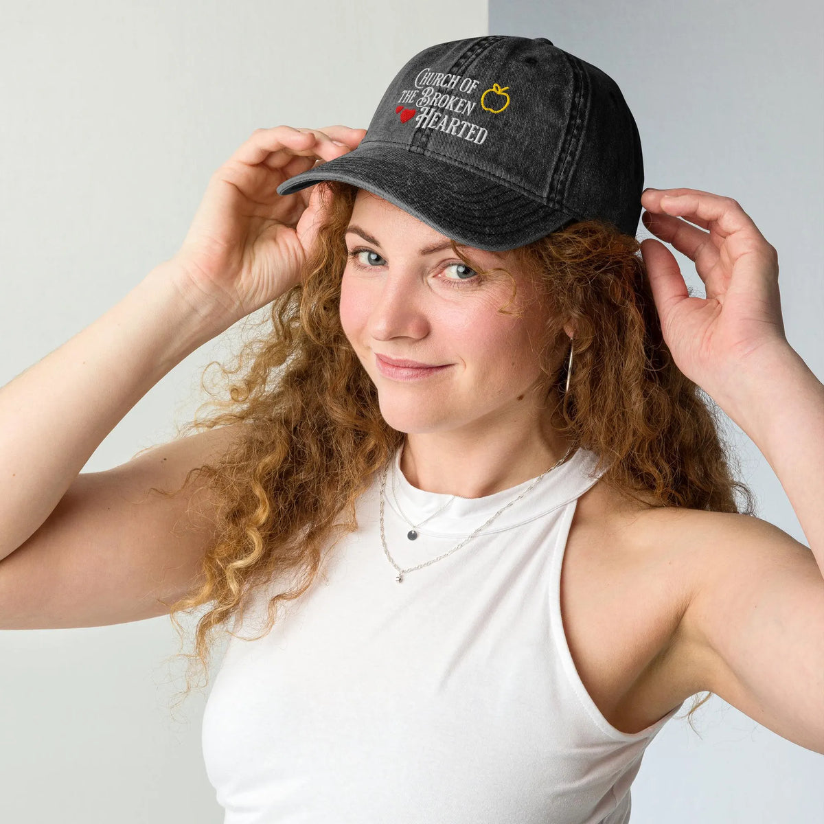 Once Upon a Broken Heart embroidered hat , distressed Vintage style hat features text that says “Church of the Broken Hearted”, with a delicate gold apple outline, and tiny red hearts. Designed by Starlit Prose Bookish Merch Australia.