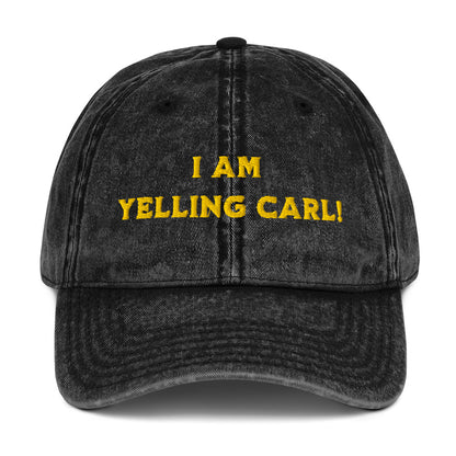 A black acid-wash baseball cap with yellow embroidered text reading 'I AM YELLING CARL!' a quote from Princess Donut of Dungeon Crawler Carl book series on the front, shown against a plain white background. Designed by Starlit Prose Bookish Merch Australia